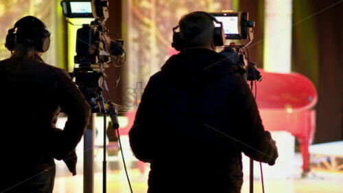 Video - Man filming with professional camera on the backstage of a TV set