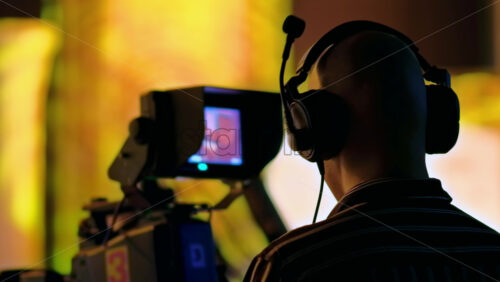 Video - Man filming with professional camera on the backstage of a TV set