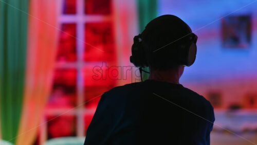 Video - Silhouette of the director of photography with an audio headset in a television studio. Backstage of the preparation for the show