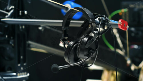Video - Audio headset hanging on a video camera crane in a television studio. Video production backstage