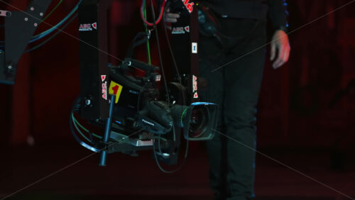 Video - Chisinau, Moldova - January 16, 2024: Professional television camera Sony with the Exmor technology mounted on a crane from ABC Products in a dark studio. Video production backstage