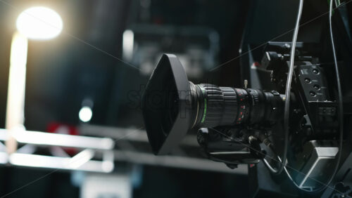 Video - Chisinau, Moldova - January 16, 2024: Professional television camera Sony with Fujifilm lenses mounted on a crane in a studio. Spotlights illuminating the scene. Video production backstage