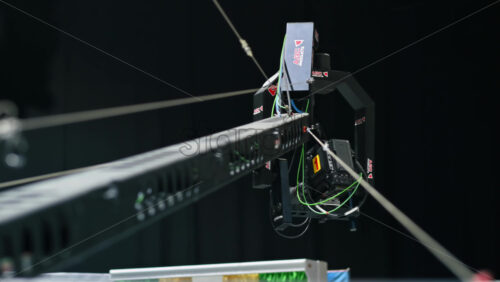 Video - Chisinau, Moldova - January 16, 2024: Professional television camera Sony mounted on a crane from ABC Products in a dark studio. Spotlights illuminating the scene. Video production backstage