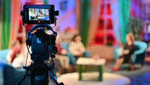 Video - Professional television camera shooting a talk show in a studio. Video production backstage