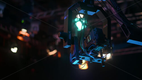 Video - Chisinau, Moldova - January 16, 2024: Professional television camera Sony mounted on a crane from ABC Products in a dark studio. Spotlights illuminating the scene. Video production backstage