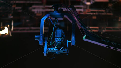 Video - Chisinau, Moldova - January 16, 2024: Professional television camera Sony mounted on a crane from ABC Products in a dark studio. Spotlights illuminating the scene. Video production backstage