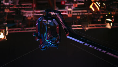 Video - Chisinau, Moldova - January 16, 2024: Professional television camera Sony mounted on a crane from ABC Products in a dark studio. Spotlights illuminating the scene. Video production backstage