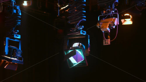 Video - Grid of professional lighting fixtures suspended in a dark television studio
