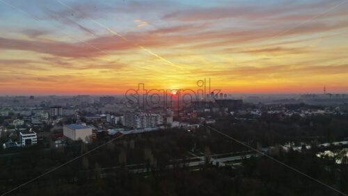 Video - Aerial drone view of Bucharest city at sunset. Flying birds. Romania