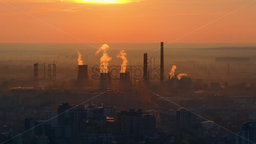 Video - Aerial drone view of thermal power stations in Bucharest at sunset. Flying birds. Romania