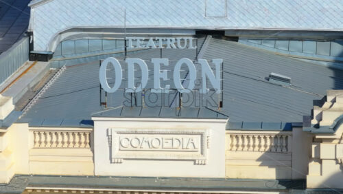 Video - Bucharest, Romania - March 03, 2024: Aerial drone view of the sign above the entrance to the Odeon theater in the sunlight