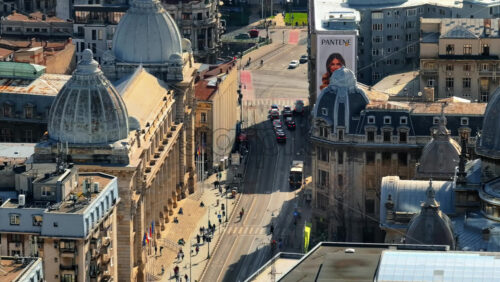 Video - Bucharest, Romania - March 03, 2024: Aerial drone view of a downtown old historical buildings in the sunlight. Moving traffic