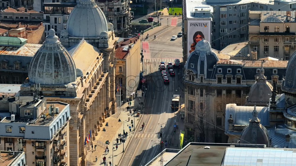 Video - Bucharest, Romania - March 03, 2024: Aerial drone view of a downtown old historical buildings in the sunlight. Moving traffic