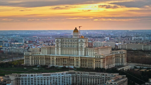 Video - Aerial drone view of Palace of the Parliament in Bucharest downtown at sunset. Multiple districts around, Romania