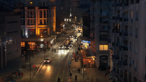 Video - Bucharest, Romania - March 03, 2024: Aerial drone view of illuminated road with moving traffic in the evening. Blue hour
