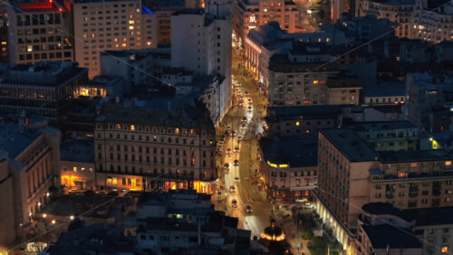 Video - Aerial drone view of illuminated Bucharest city in the evening. Moving traffic. Blue hour, Romania