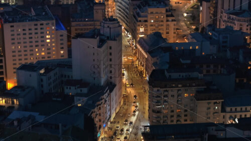 Video - Aerial drone view of illuminated Bucharest city in the evening. Moving traffic. Blue hour, Romania