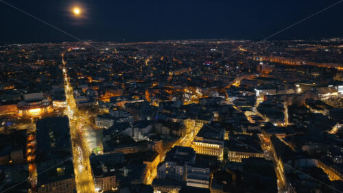 Video - Aerial drone view of illuminated cityscape in the evening. Blue hour in Bucharest, Romania