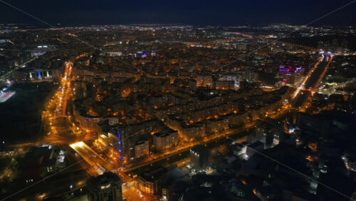 Video - Aerial drone view of illuminated cityscape in the night. Bucharest, Romania