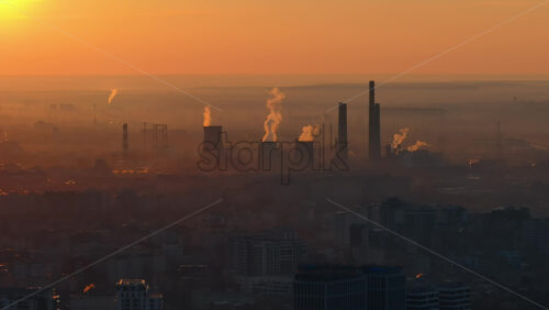 Video - Aerial drone view of thermal power stations in Bucharest at sunset. Flying birds. Romania