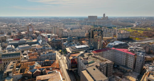 Video - Bucharest, Romania - March 03, 2024: Aerial drone view of the city center with the Palace of Parliament in the background. Sunny day