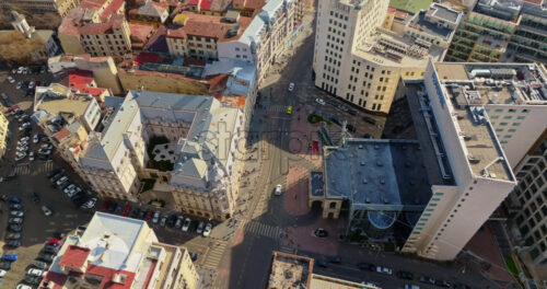 Video - Bucharest, Romania - March 03, 2024: Aerial drone top view of the city center with moving traffic in sunlight