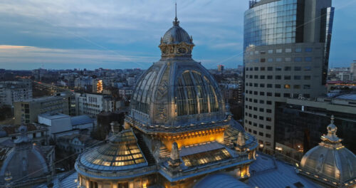 Video - Aerial drone view of the illuminated dome of Palace of the Deposits and Consignments in the evening. Blue hour in Bucharest, Romania