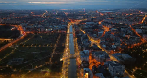 Video - Aerial drone view of the illuminated city in the evening. Moving traffic. Blue hour in Bucharest, Romania