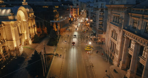 Video - Bucharest, Romania - March 03, 2024: Aerial drone view of illuminated road with moving traffic in the evening. Blue hour