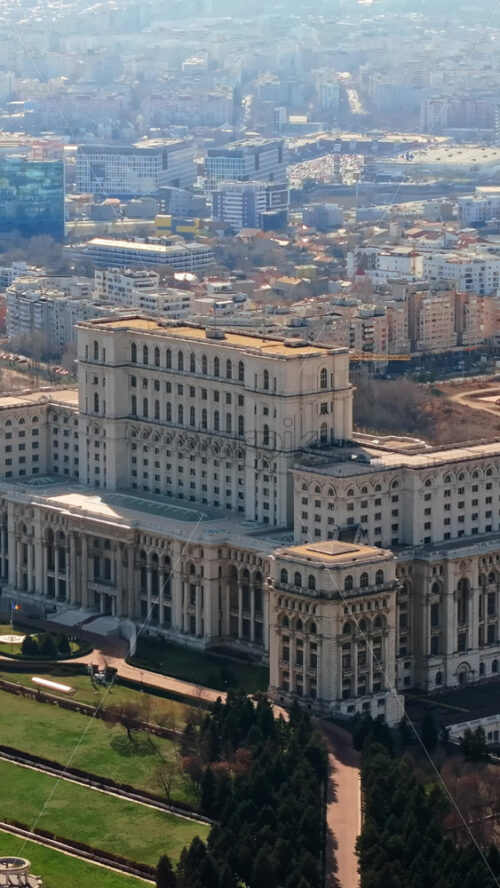 Video - Vertical aerial drone view of Palace of the Parliament in Bucharest downtown in sunlight. Romania