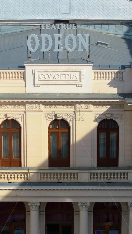 Video - Vertical aerial drone view of Odeon theater in the sunlight in Bucharest, Romania