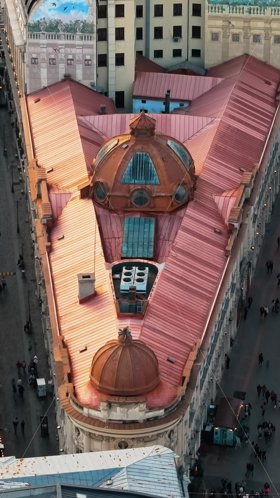 Video - Bucharest, Romania - March 03, 2024: Vertical aerial drone view of Pinacotecii palace building with walking people in the old town