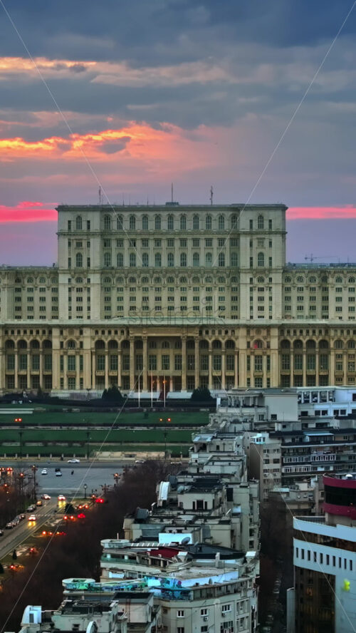 Video - Vertical aerial drone view of Palace of the Parliament in Bucharest downtown at sunset. Romania