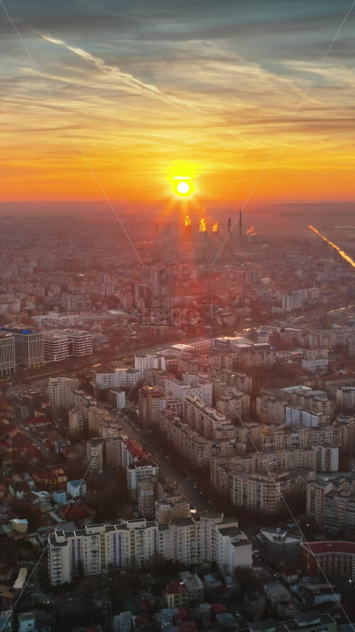 Video - Vertical aerial drone view of Bucharest city at sunset. Moving traffic. Romania