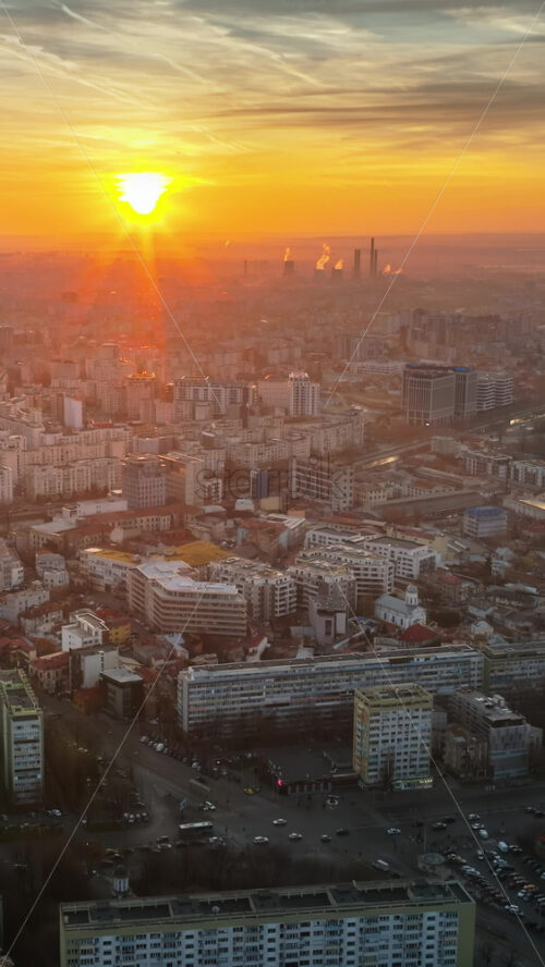 Video - Vertical aerial drone view of Bucharest city at sunset. Moving traffic. Romania
