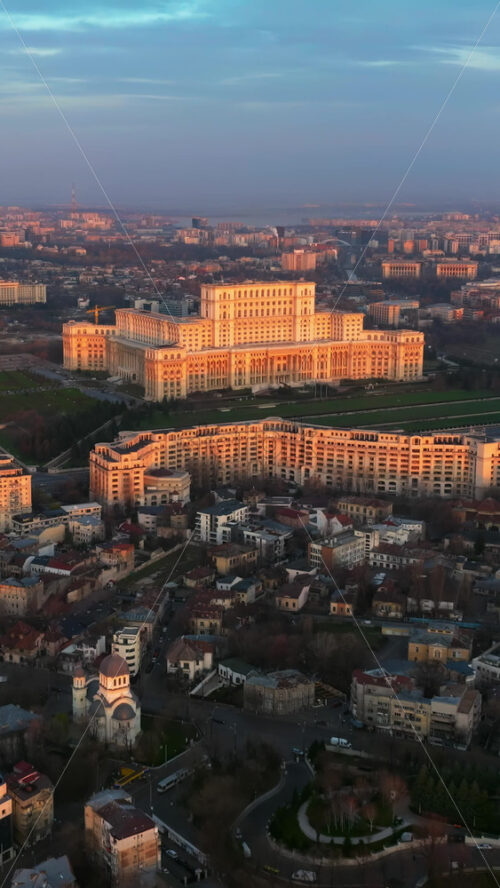 Video - Vertical aerial drone view of Palace of the Parliament in Bucharest downtown at sunset. Romania