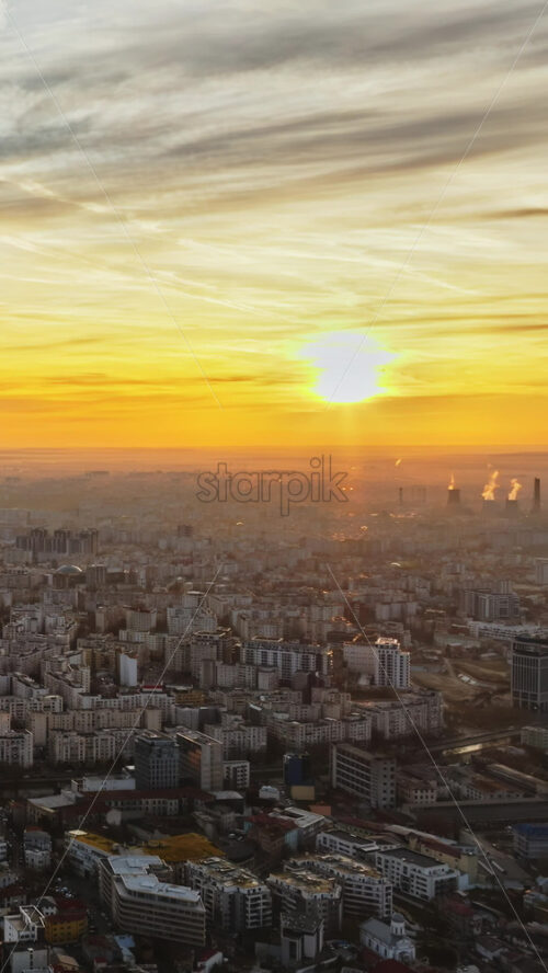 Video - Vertical aerial drone view of Bucharest city at sunset. Moving traffic. Romania