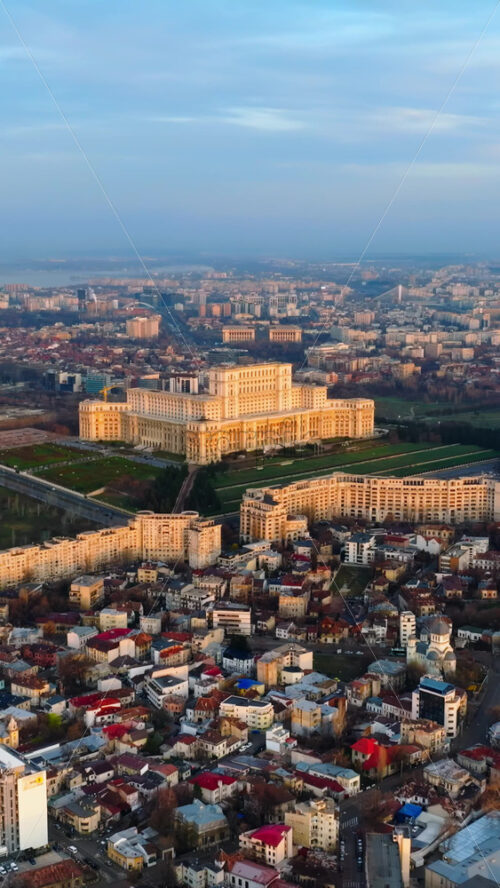 Video - Vertical aerial drone view of Palace of the Parliament in Bucharest downtown at sunset. Romania
