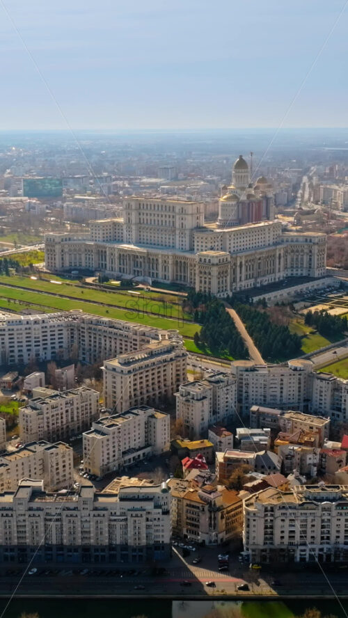 Video - Vertical aerial drone view of Palace of the Parliament in the city center. Sunny day. Bucharest, Romania
