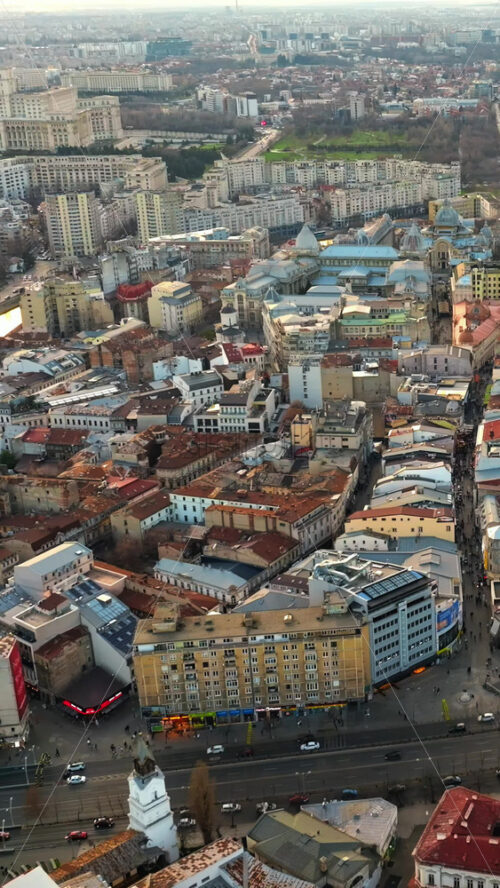 Video - Vertical aerial drone view of Bucharest city at sunset. Moving traffic. Romania