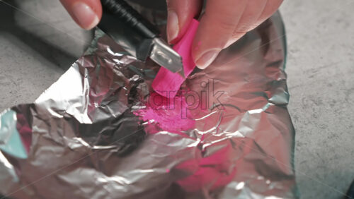 Video - Hand made candles production, woman preparing a pink dye for wax