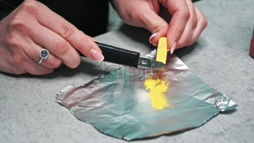 Video - Hand made candles production, woman preparing a yellow dye for wax. Slow motion