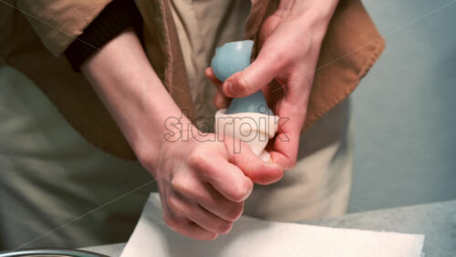 Video - A woman occupied with hand made candles production