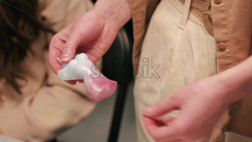Video - A woman occupied with hand made candles production