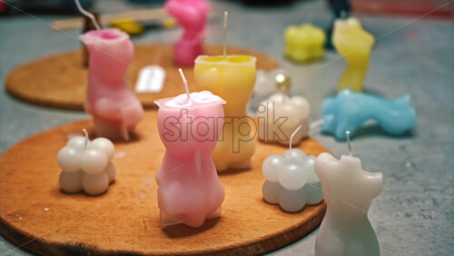 Video - Hand made colored candles in different forms on the table