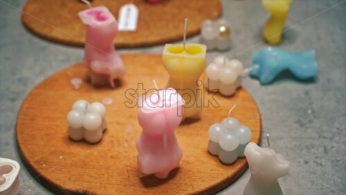 Video - Hand made colored candles in different forms on the table