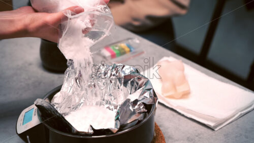 Video - CHISINAU, MOLDOVA - MARCH 25, 2021: Few women occupied with hand made candles production, adding wax to a pot