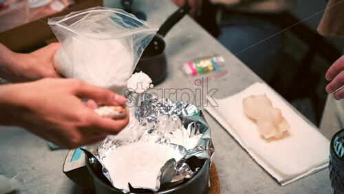 Video - Few women occupied with hand made candles production, adding wax to a pot. Slow motion