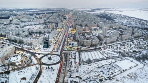 Video - Aerial drone view of Chisinau city covered in snow with moving traffic. Winter in Moldova