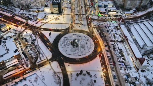 Video - Aerial drone view of Chisinau city covered in snow with moving traffic in the evening. Winter in Moldova